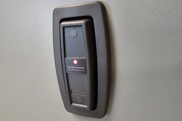 Access control card reader installed beside a door