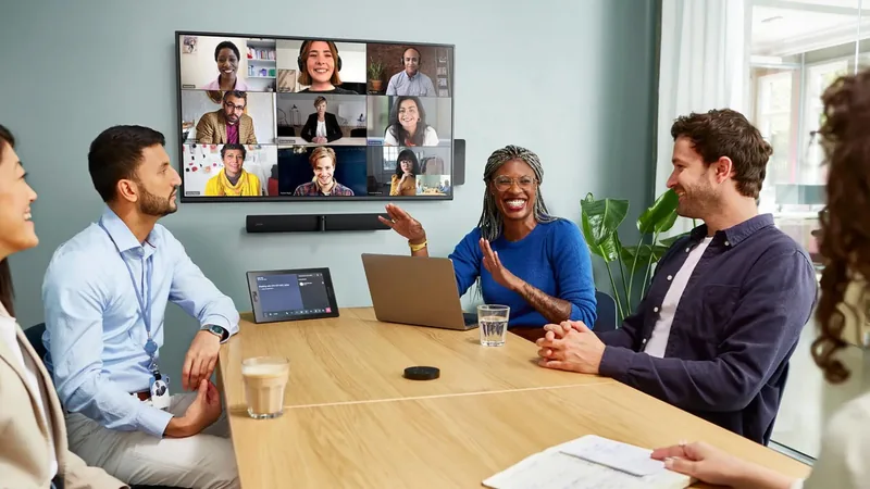 Hybrid and video conferencing AV systems Hybrid meeting with remote participants on a wall display and a video bar mounted below