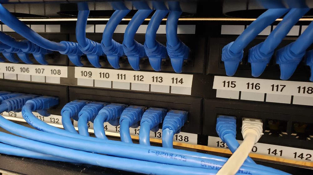 Numbered patch panel ports with matching labels and blue patch cords