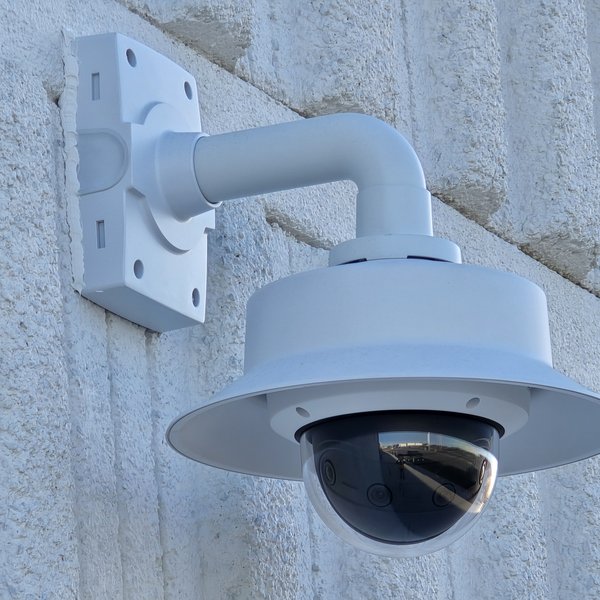 Outdoor dome security camera on a wall arm mount