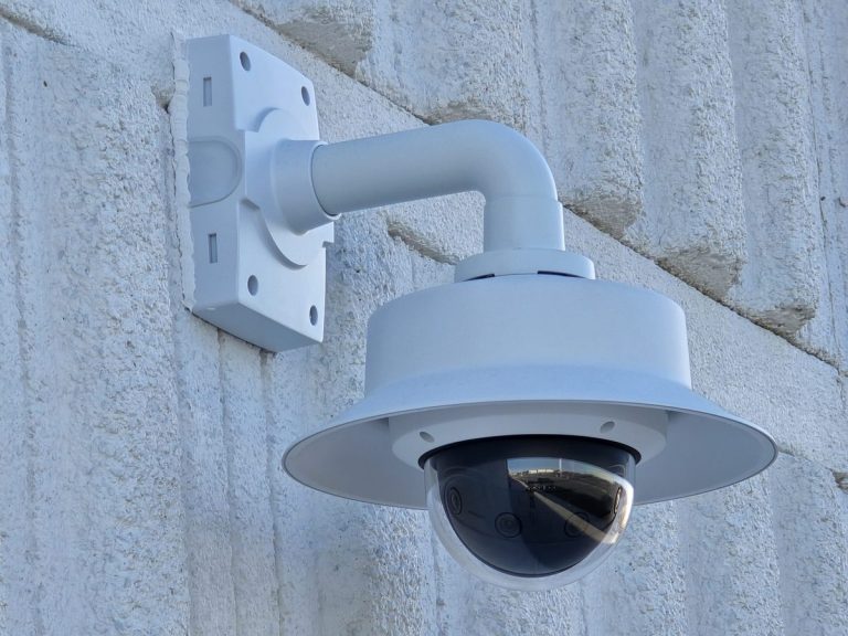 Outdoor dome security camera on a wall-arm mount
