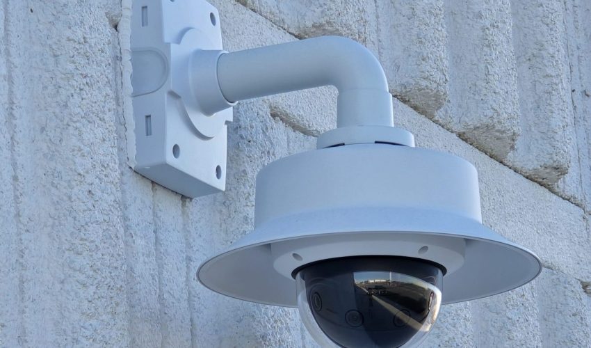 Outdoor dome security camera on a wall-arm mount