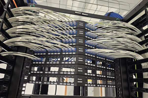 Structured cabling rack with dressed cable looms feeding patch panels