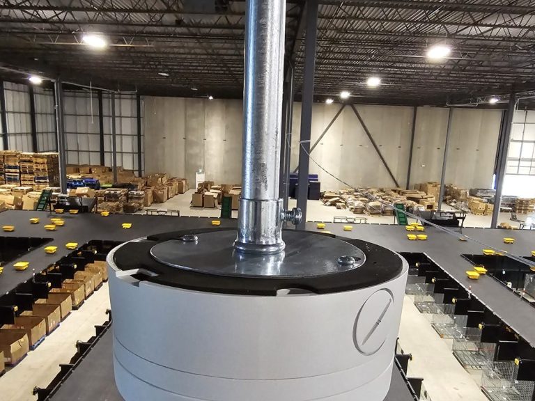 Security camera on a pendant mount above a warehouse sorting floor